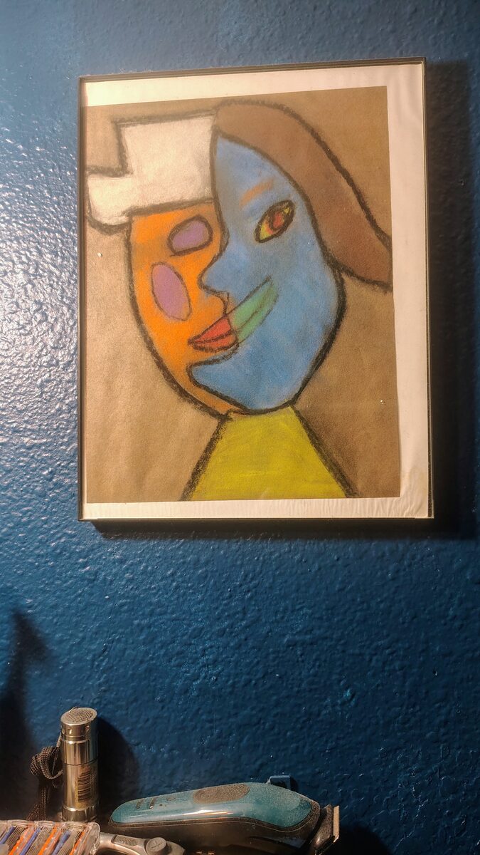 Original abstract face painting in orange, blue, and yellow pastel by artist Xavier de la Rosa